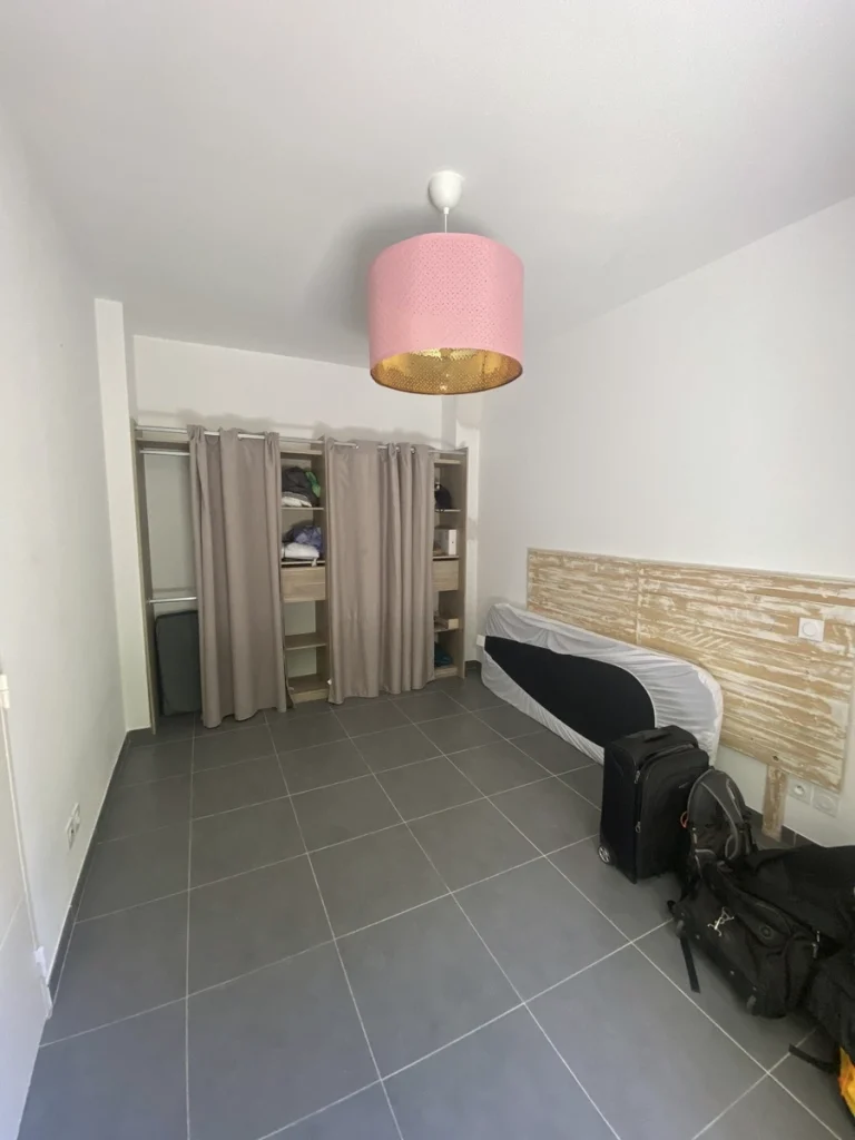 Chambre avant travaux, sol gris et penderie à rideaux, projet Parengon par Maison Solthée, architecte d'intérieur à Marseille