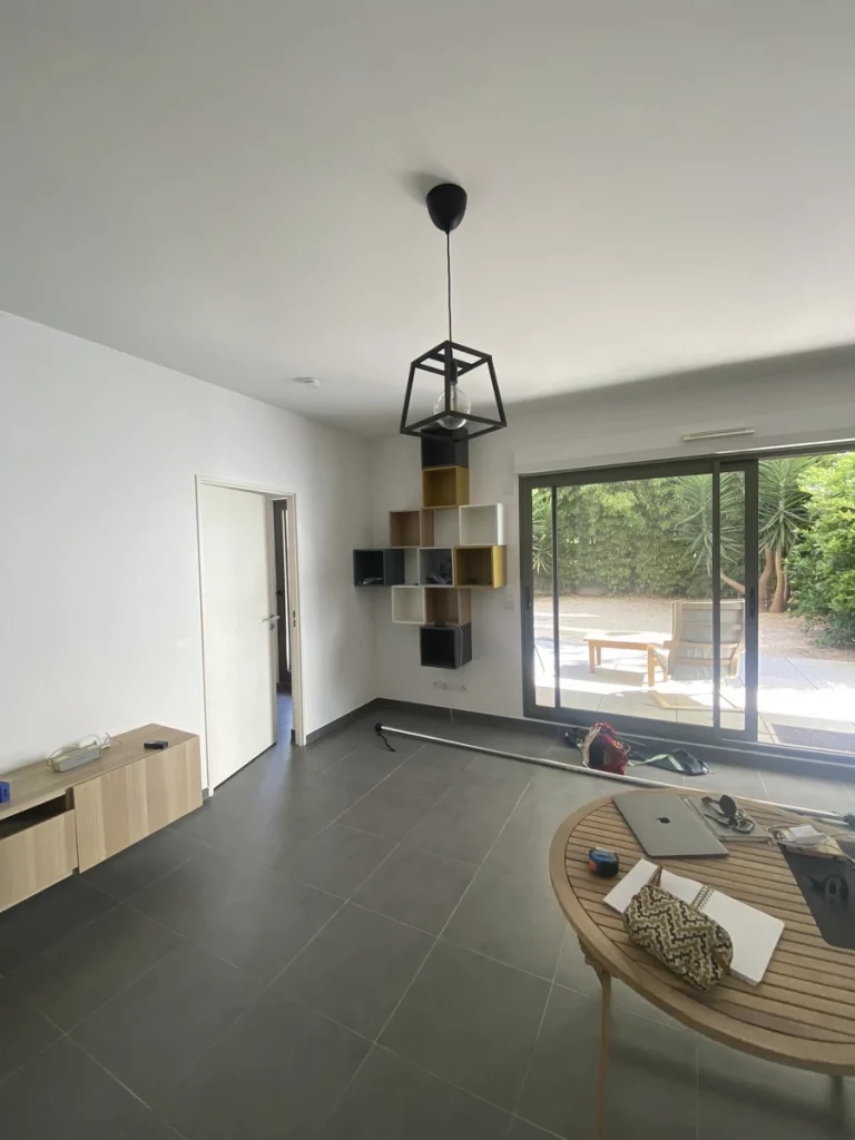 Séjour avant travaux, baie vitrée et sol gris, projet Parengon par Maison Solthée, architecte d'intérieur à Marseille